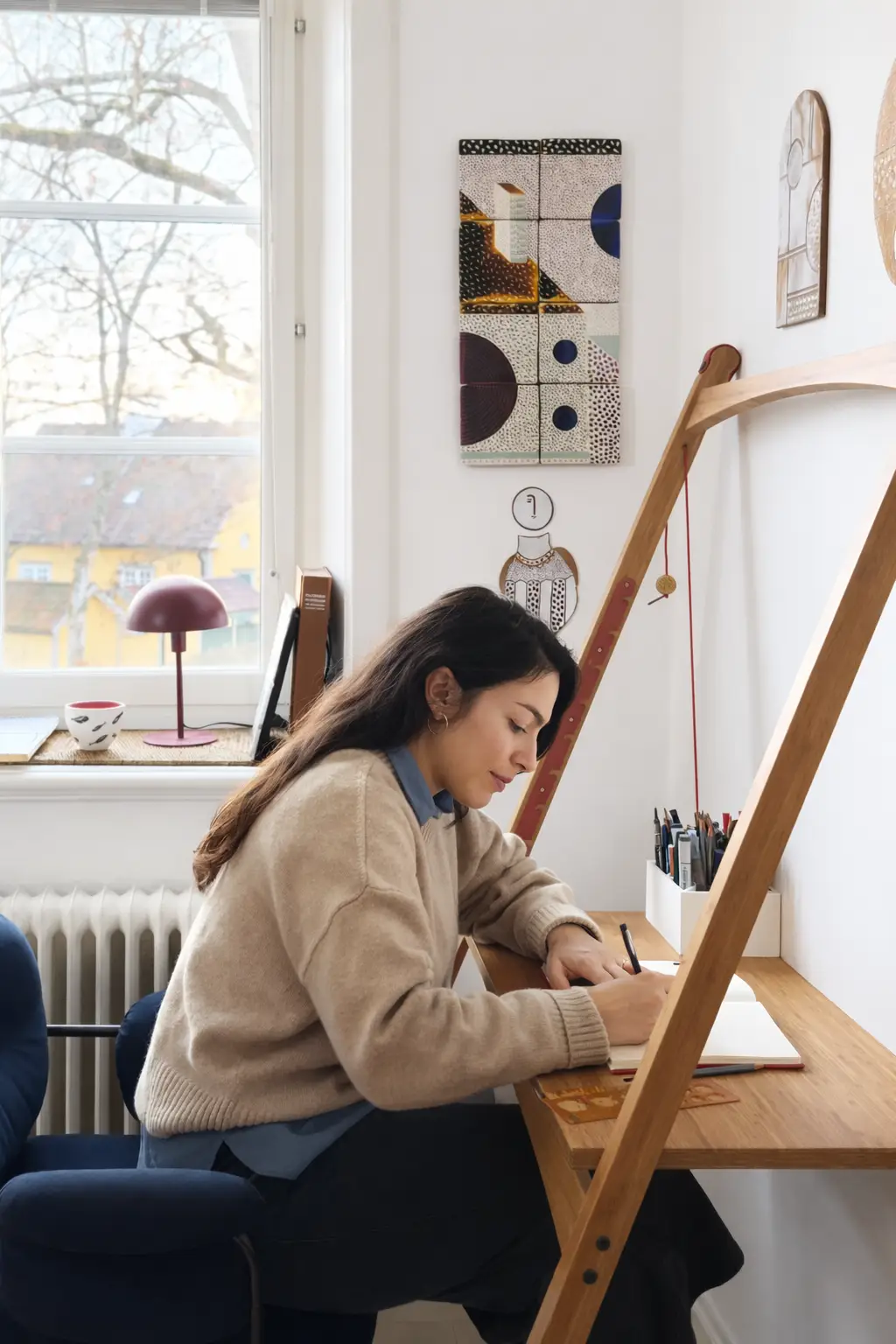 Close-up of Leandesk bamboo folding desk being used as a drawing surface for illustration and craft work