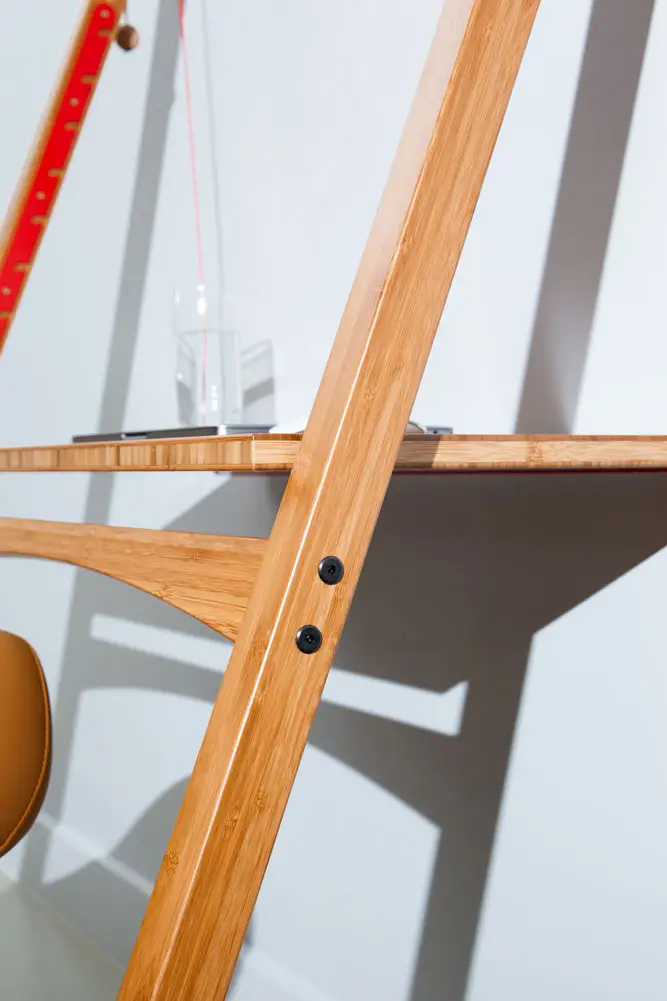 Close-up of Leandesk portable desk for photographers in a clean studio setup with laptop and camera gear