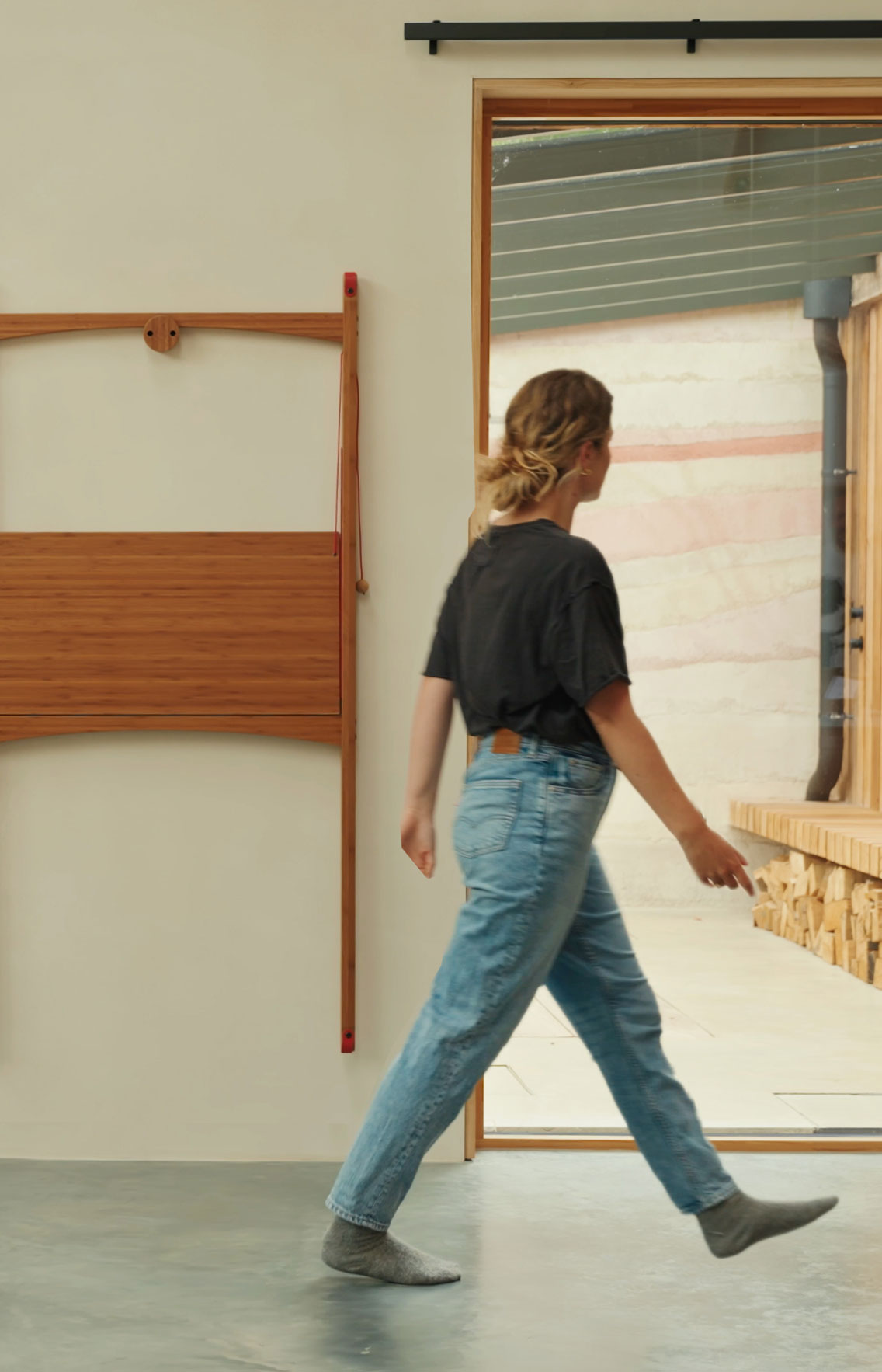 Compact wooden desk folded and hung on wall for easy storage in a small living space