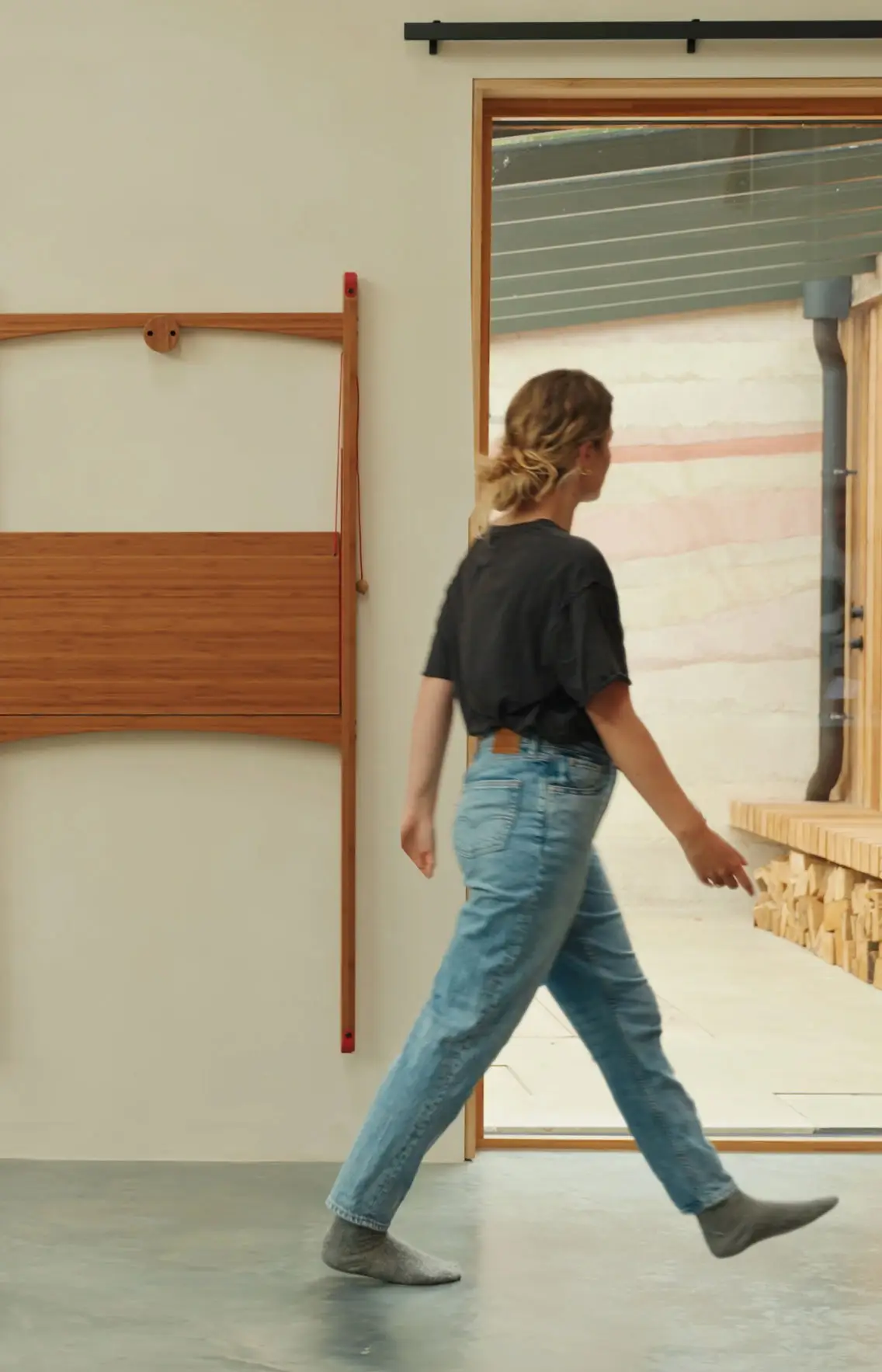 Compact wooden desk folded and hung on wall for easy storage in a small living space