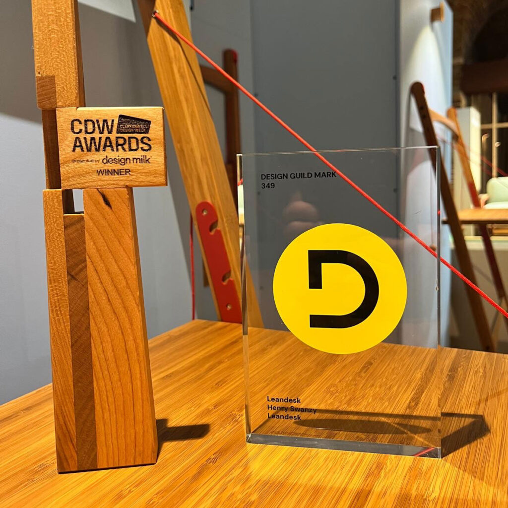 Henry Swanzy's Leandesk with the two awards presented at Clerkenwell Design Week - CDW Awards 2026 Residential Furniture Winner and Design Guild Mark Award.